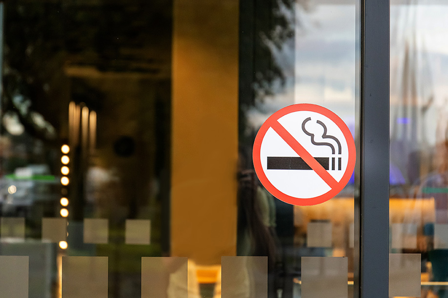 No Smoking symbol on the window of a store